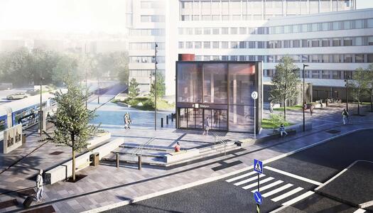 Vy över ett modernt stadstorg med ett glasinklätt entrébyggnad i centrum. Gator med övergångsställen och cykelvägar omger torget. Träd och bänkar är utspridda, och människor promenerar och cyklar i området. Bakgrunden domineras av höga kontorsbyggnader.